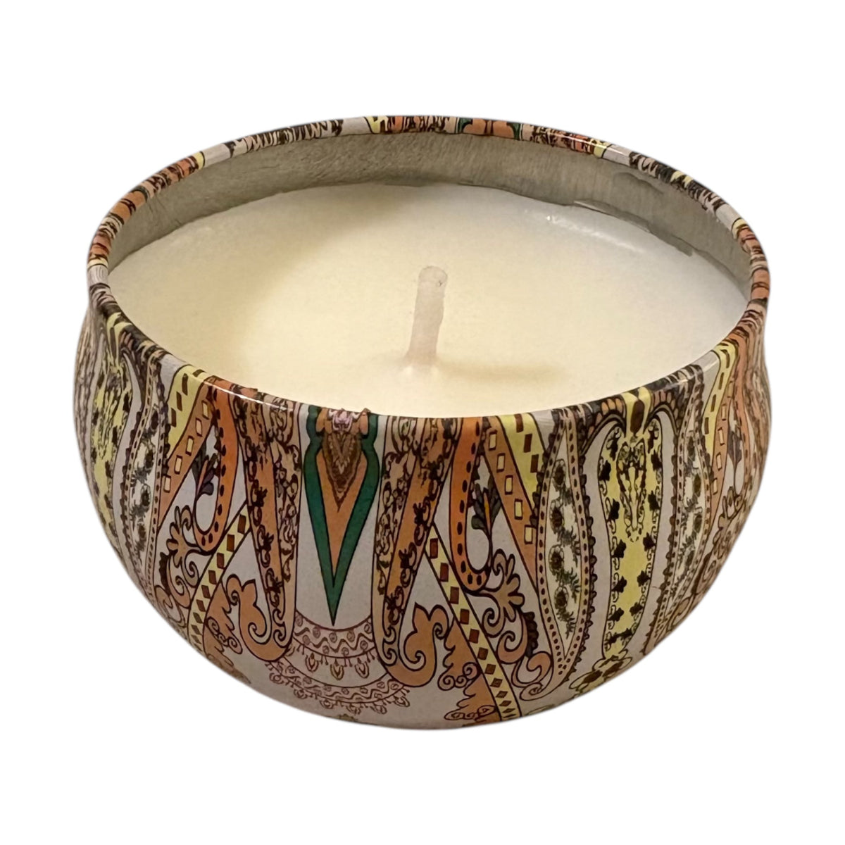 Candle in a decorative tin with intricate patterns on a white background