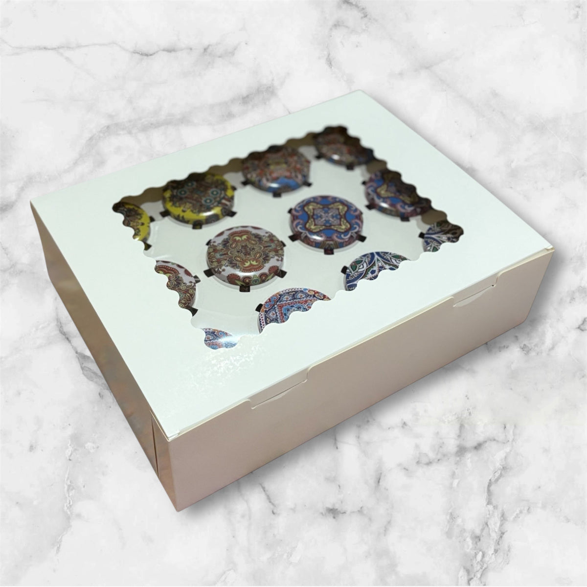 Decorative items in a box with a clear lid on a marble surface