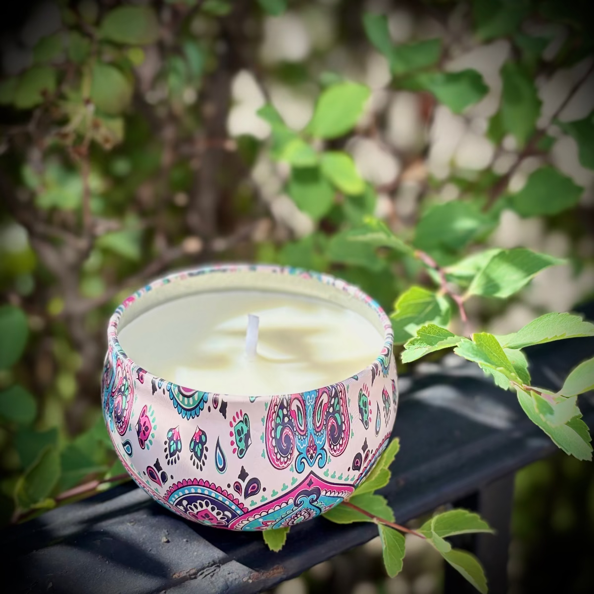 Decorative candle in a colorful holder with a natural background