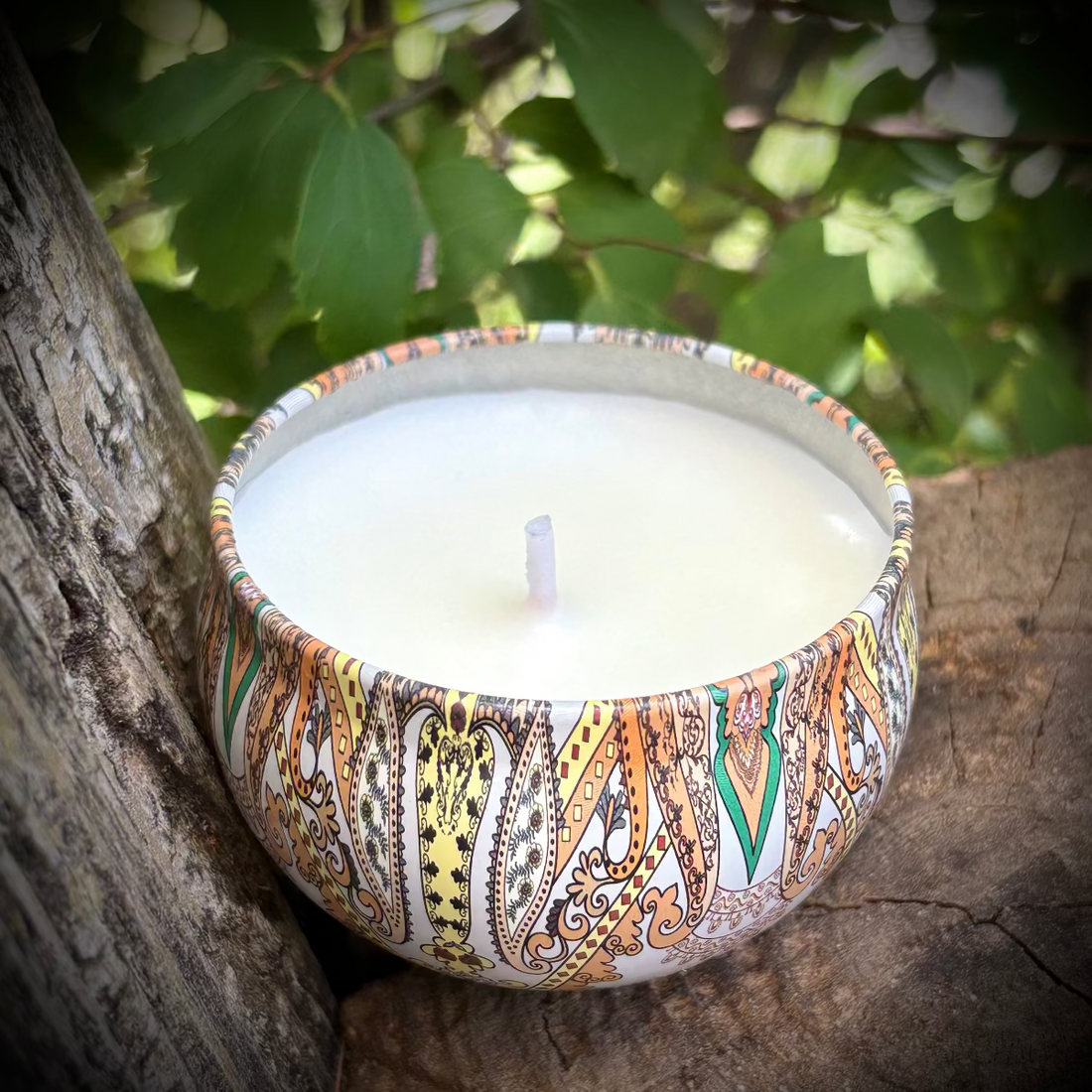Decorative candle in a patterned holder on a natural background