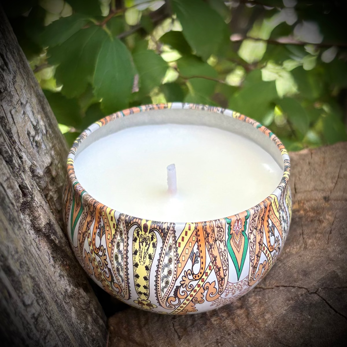 Decorative candle in a patterned holder on a natural background