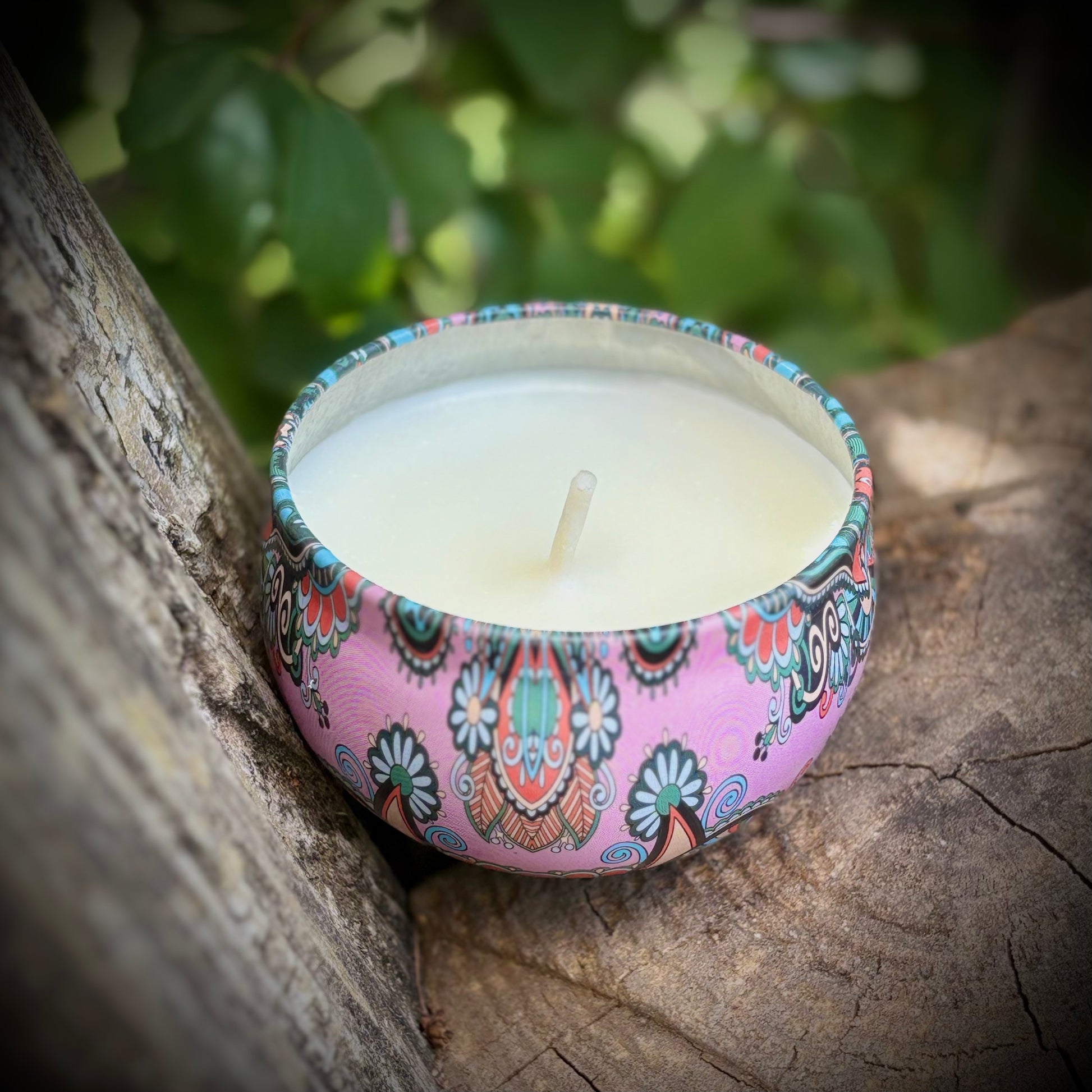 Decorative candle with a colorful pattern on a wooden surface
