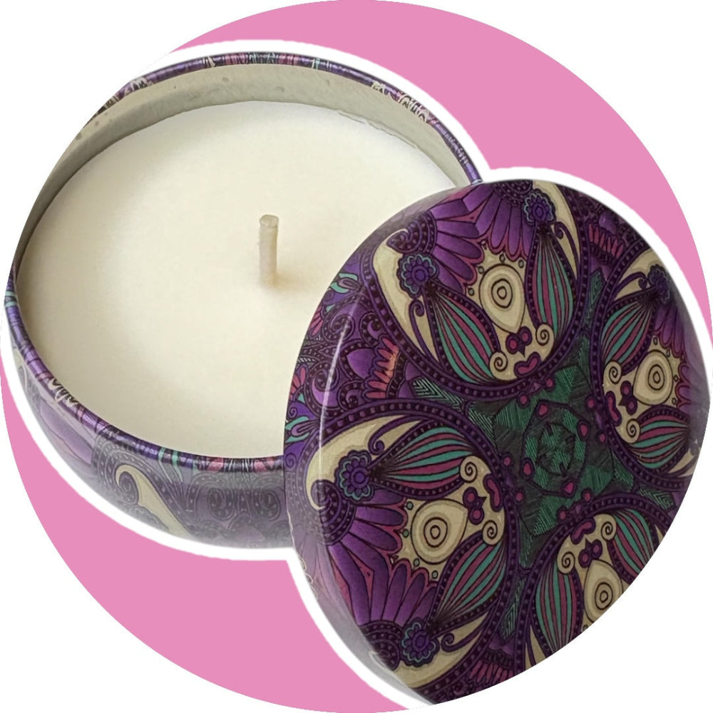 Decorative candle with a purple and green patterned lid on a pink background