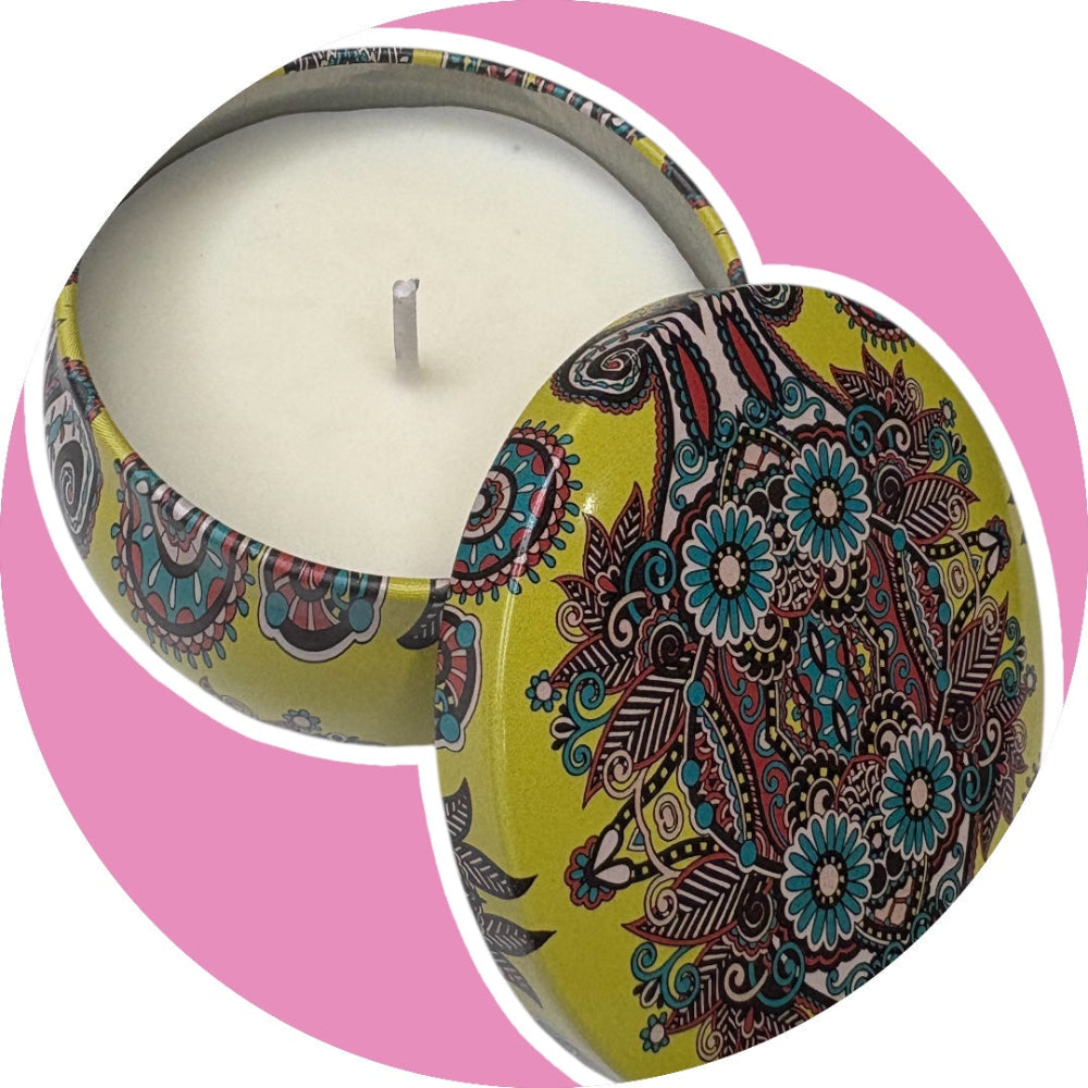 Decorative candle in a colorful tin with a pink background