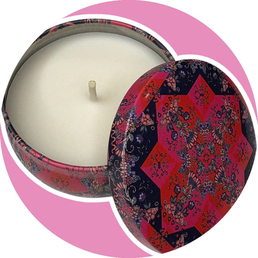 Decorative candle with a colorful patterned lid on a pink background