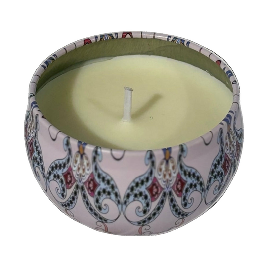 Candle in a decorative tin with a colorful pattern on a white background