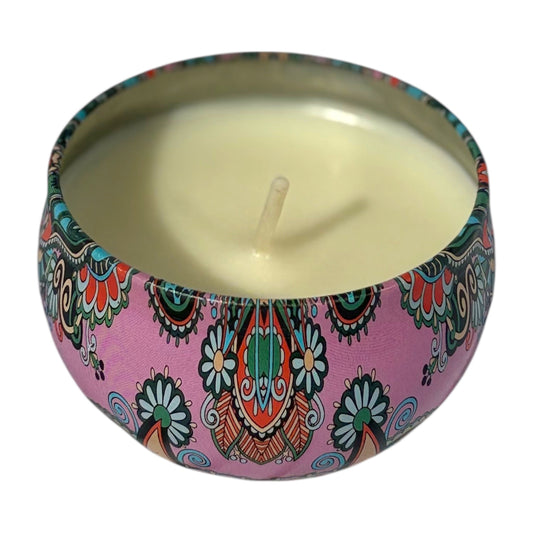 Candle in a decorative pink tin with colorful patterns on a white background
