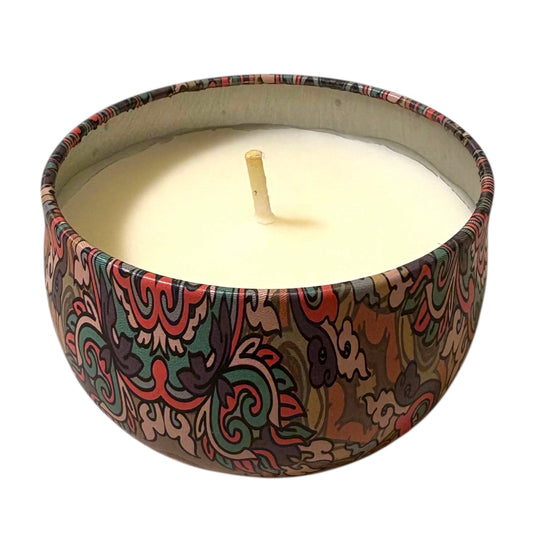 Candle in a decorative container with a colorful pattern on a white background