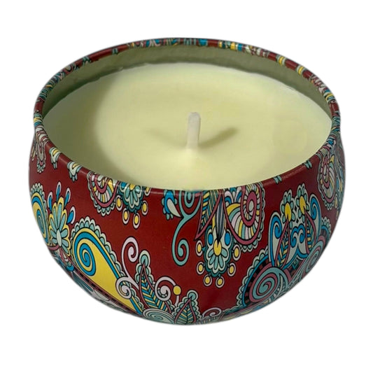 Candle in a colorful tin with a paisley design on a white background