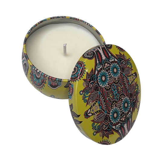 Candle in a decorative tin with floral pattern on a white background