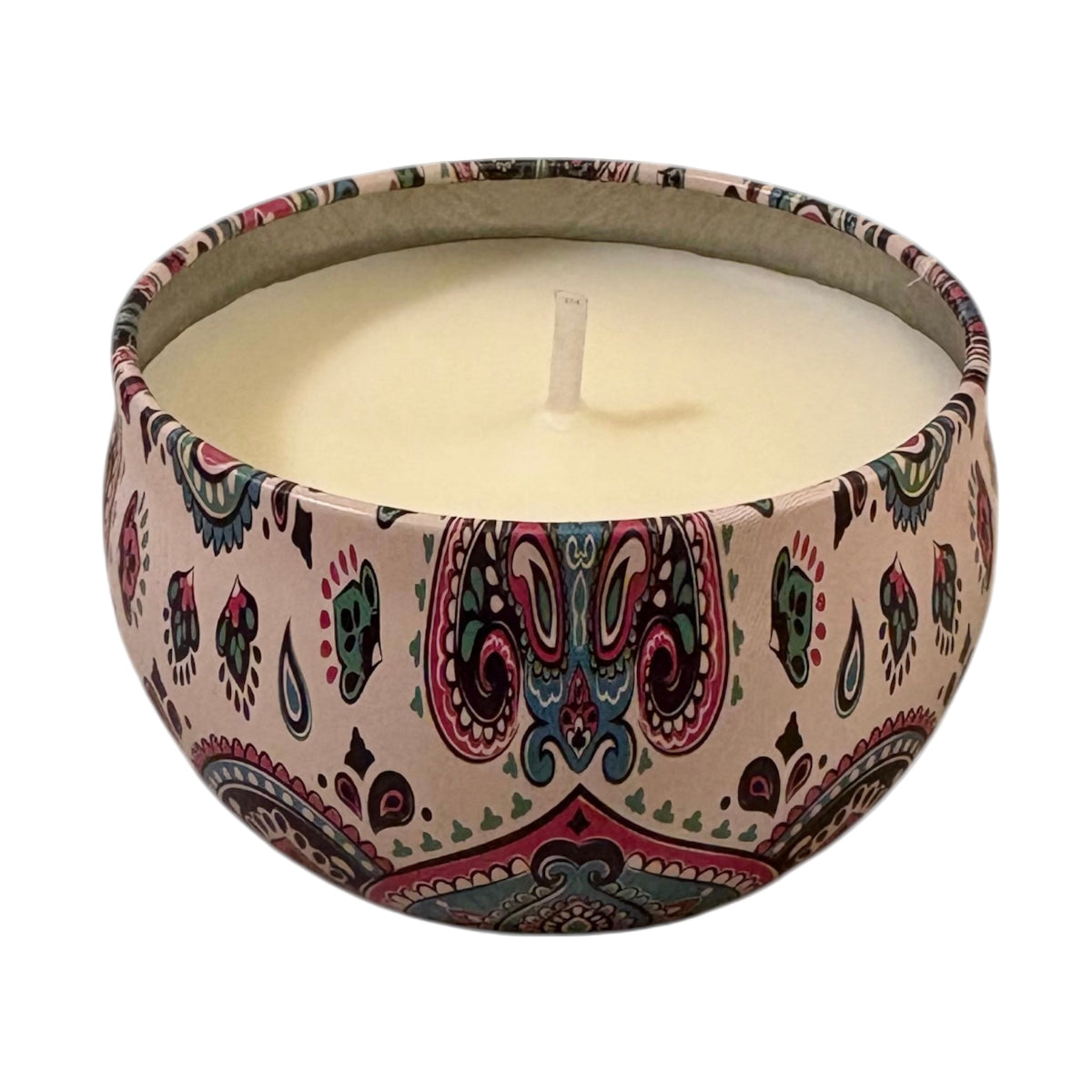 Candle in a decorative container with paisley pattern on a white background