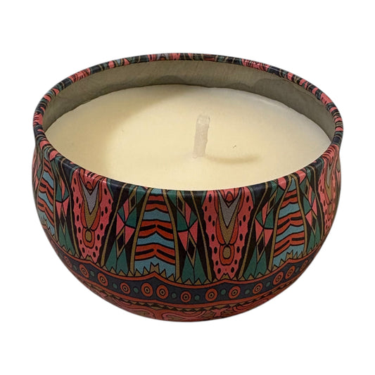 Candle in a colorful, patterned container on a white background