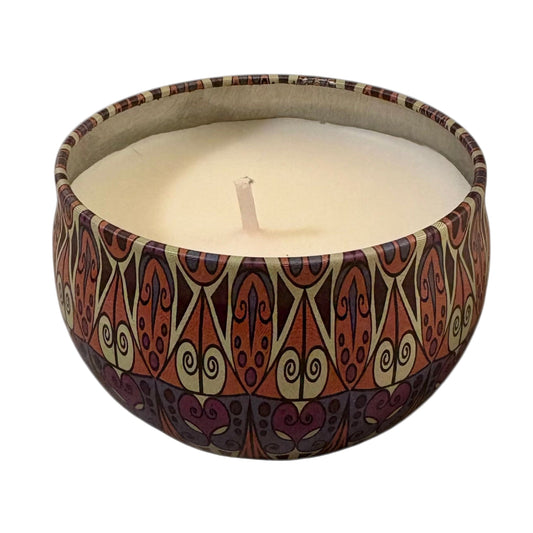 Candle in a decorative container with a pattern on a white background