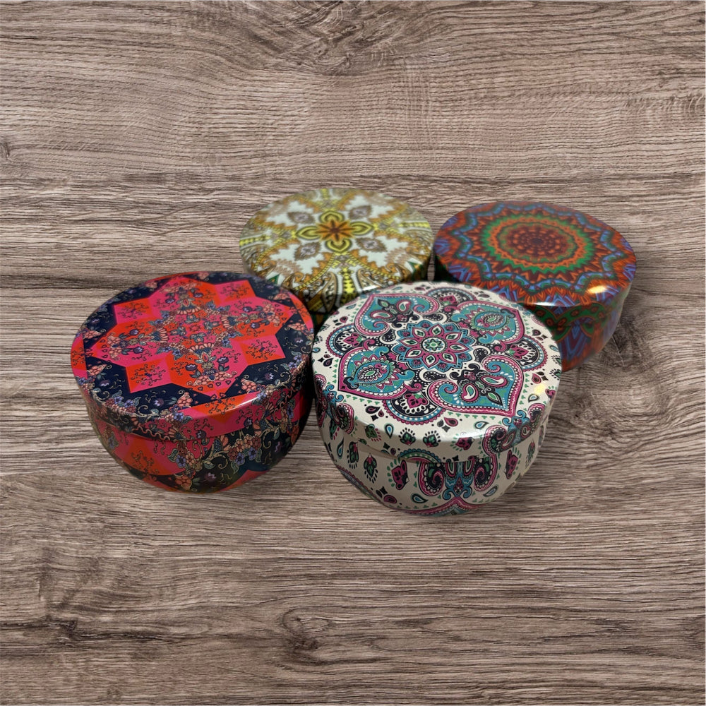 Four colorful patterned boxes on a wooden surface
