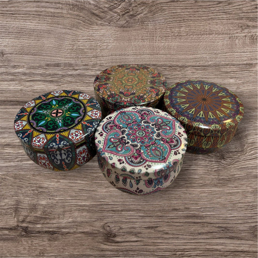 Four decorative boxes with intricate patterns on a wooden surface